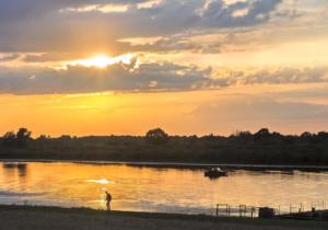 Evening Landscape: Sunset Over A Small River